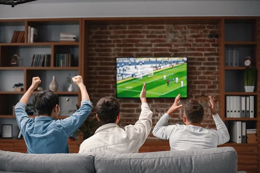 Family watching live sports and series through an Iptv UK subscription on a Smart TV